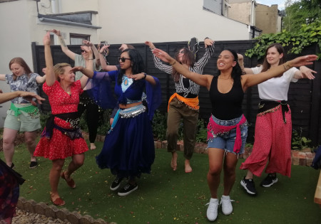 Woman belly dancing in a garden