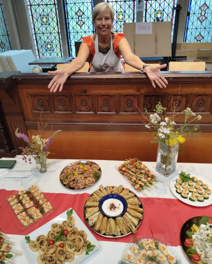 Wafaa_buffet A lady showing a table full of Lebanese food