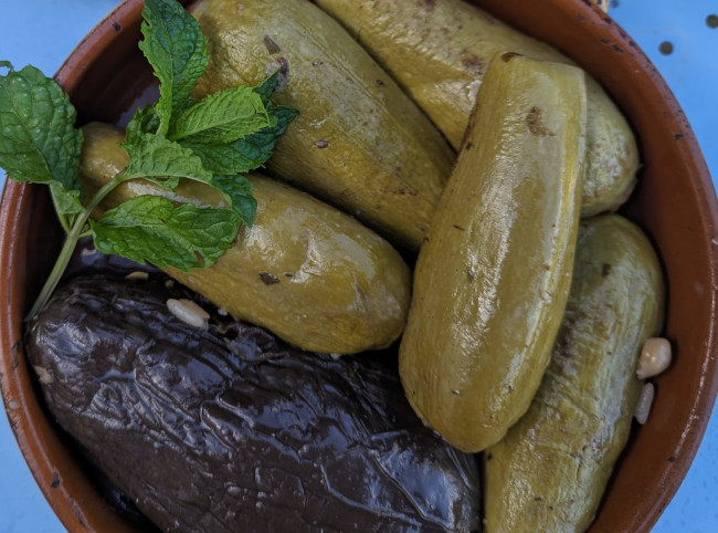 Stuffed courgettes and aubergine A dish of rice and courgettes and onions