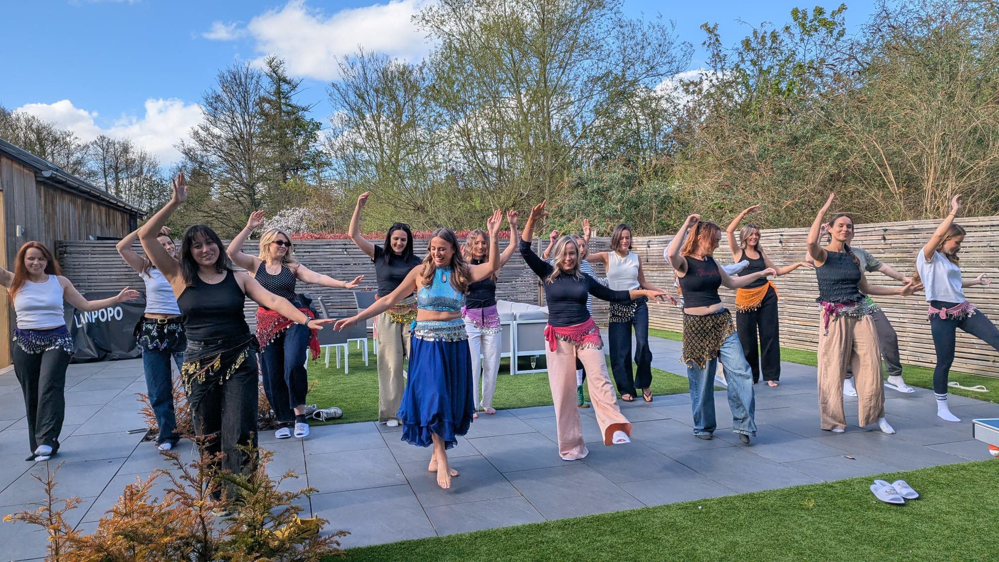 A group of women belly dancing outside